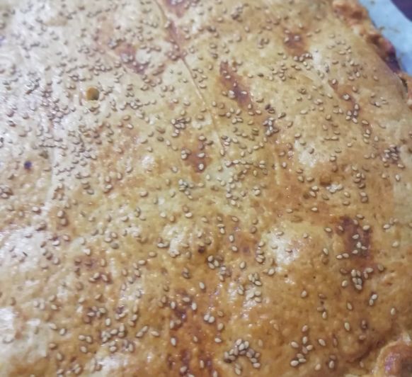 EMPANADA DE LANGOSTINOS, QUESO CREMA Y CEBOLLA CONFITADA